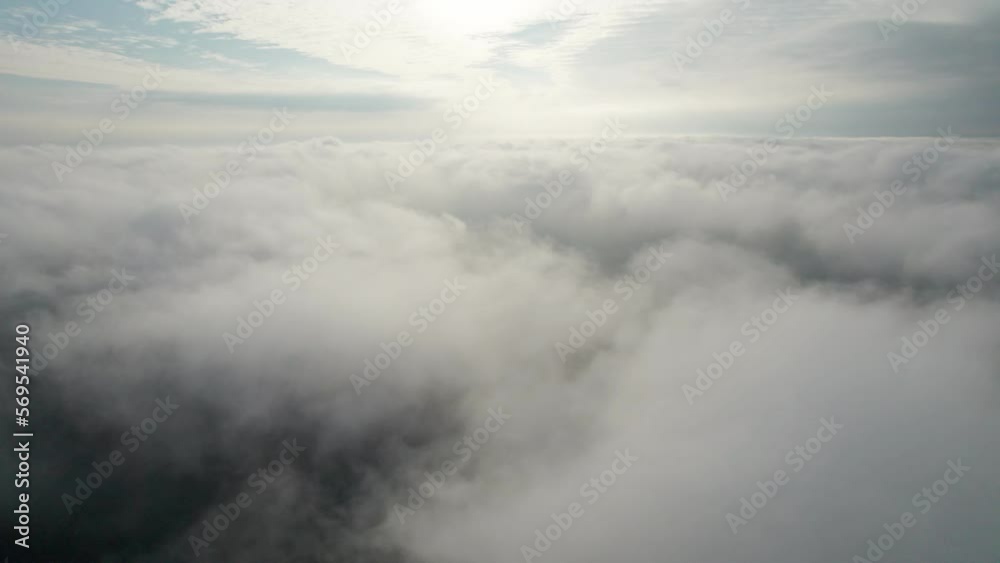 Flight in the clouds at low altitude. View from the cockpit of an airplane, glider.