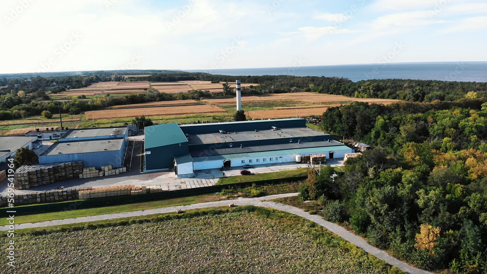 CHERKASY REGION, UKRAINE, SEPTEMBER 17, 2018: big apple packing plant, enterprise, factory in the middle of field. many warehouses and industrial buildings, large trucks, CHERKASY REGION, UKRAINE, SEPTEMBER 17, 2018: big apple packing plant, enterprise, factory in the middle of field. many warehouses and industrial buildings, large trucks,