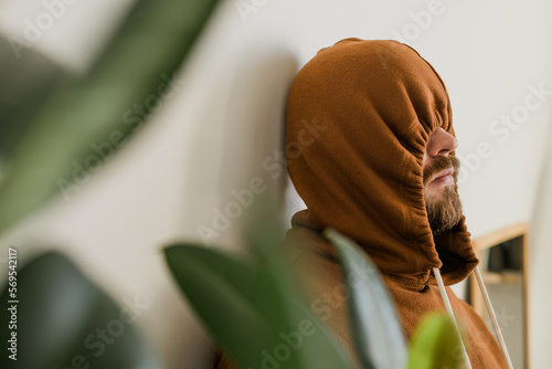 Fotografiet Depressed unhappy man covered hood her face - escapism and loneliness mental problem concept