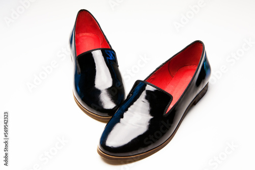 a pair of women s shoes  lacquer  leather  with red middle  without a heel on a white background with close