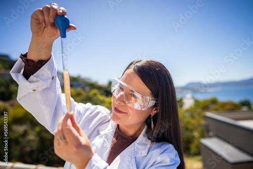 Canvas Print soil scientist agronomist farmer looking at soil samples and grass in a field in spring