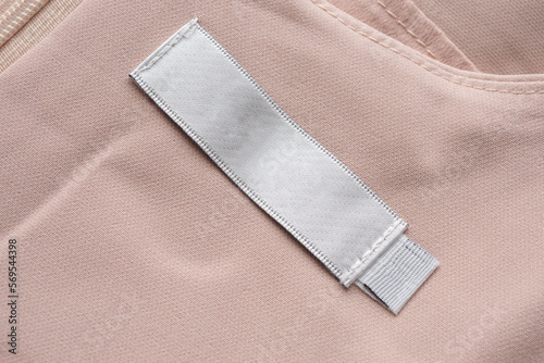 Blank laundry care clothes label on fabric texture background