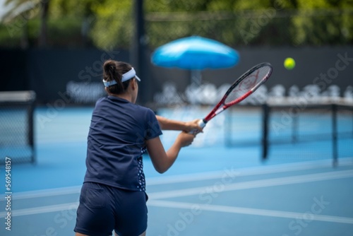 Beautiful female athlete playing tennis. Amateur female tennis player hitting a forehand playing tennis summer photo