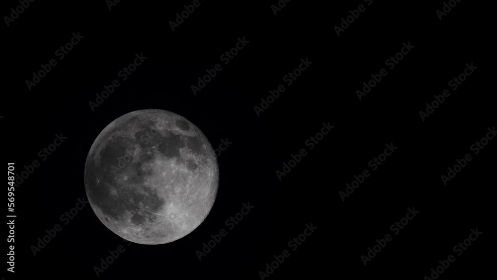Fast clouds pass by in front of the moon. Fast clouds pass by in front of the moon.
