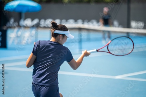 female Professional athlete Tennis player playing on a court in a tennis tournament in summer in australia
