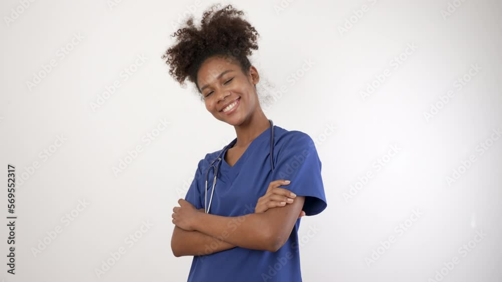 Doctor nurse black woman in blue uniform standing with her arms crossed, looking at camera.