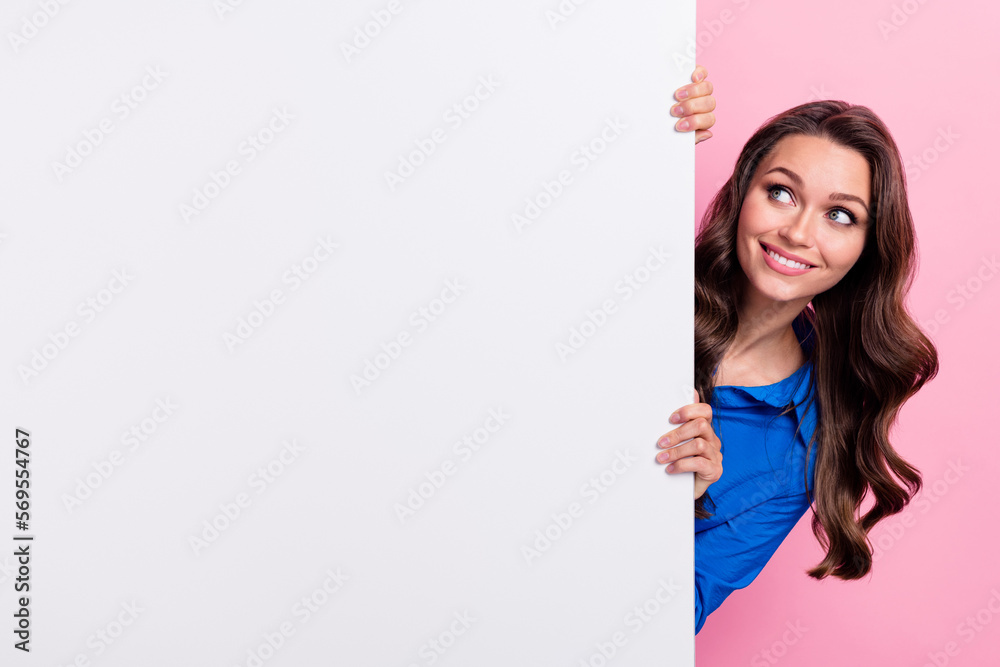 Photo of adorable stunning lady wear blue stylish clothes hiding behind empty space nice offer low prices isolated on pink color background Photo of adorable stunning lady wear blue stylish clothes hiding behind empty space nice offer low prices isolated on pink color background