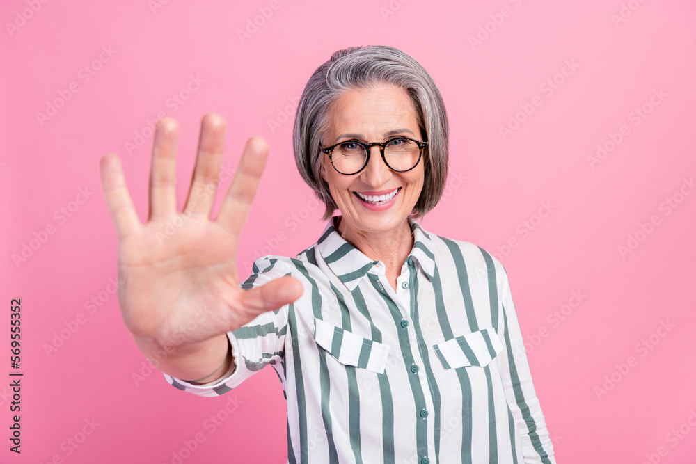 Photo of pretty charming woman dressed smart casual outfit showing palm five fingers isolated pink color background Photo of pretty charming woman dressed smart casual outfit showing palm five fingers isolated pink color background