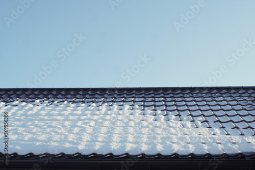 snow on the roof of metal tiles