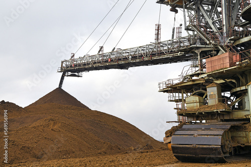 An huge excavator on a coal surface mine. Interesting geological forms of tailings dump in an open pit coal mine.