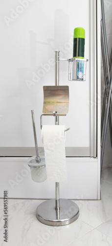 Modern chrome stand for toilet paper and air freshener.