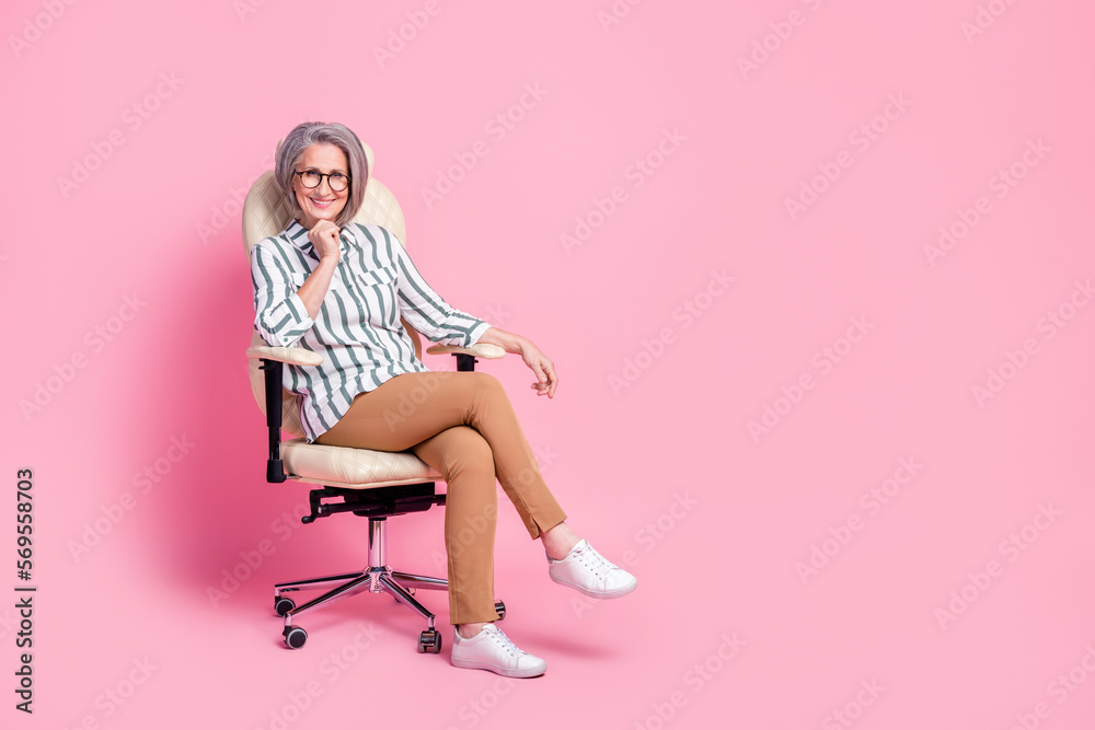 Fototapeta premium Full length photo of adorable cute woman dressed smart casual arm chin sitting leather office chair isolated pink color background