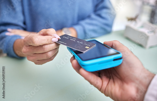 Shopping, hands or payment with a credit card by a customer checkout transaction at optometrist. Finance, zoom or people make a fintech electronic machine purchase or point of sale at a retail store