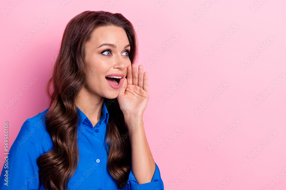 Portrait of good mood pretty nice girl wavy hairstyle wear blue shirt look empty space palm near cheek isolated on pink color background Portrait of good mood pretty nice girl wavy hairstyle wear blue shirt look empty space palm near cheek isolated on pink color background