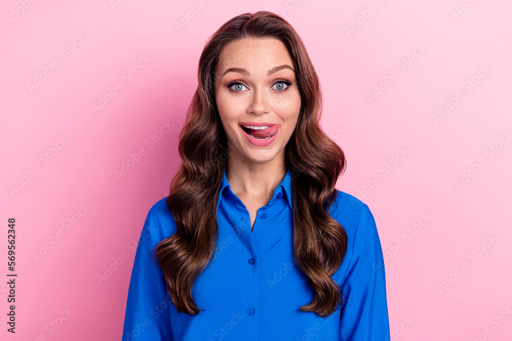 Portrait of pretty good mood optimistic girl with wavy hairstyle wear blue shirt tongue lick lips isolated on pink color background Portrait of pretty good mood optimistic girl with wavy hairstyle wear blue shirt tongue lick lips isolated on pink color background