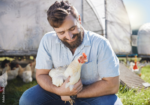 Man on farm, chicken and agriculture with happiness, poultry livestock with sustainability and organic free range. Agro business, farming and environment with animal, happy farmer in countryside photo