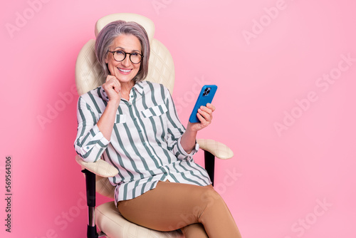 Photo of cute pretty woman dressed smart casual outfit chatting modern device empty space isolated pink color background