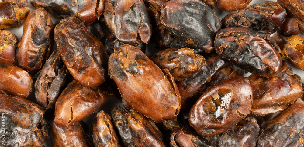 Close-ups of ripe dried dates. Visible cracks in the shiny skin. Close-ups of ripe dried dates. Visible cracks in the shiny skin.