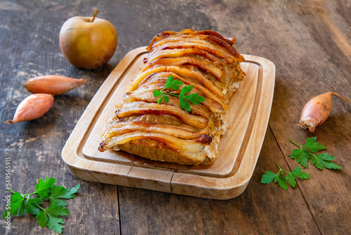 Pork loin baked with apples, spring onions and slices of pork fat