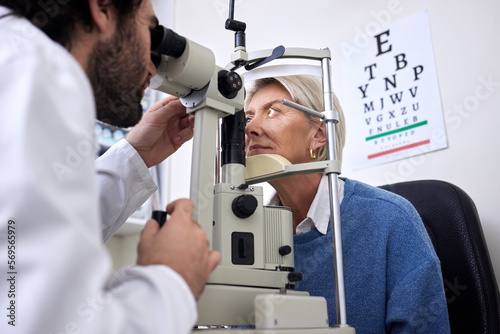 Vision, machine exam and woman with an optometrist for a check, eye consultation and lens test. Healthcare, help and male optician with a senior patient to measure visual eyesight with equipment