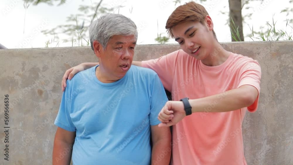 Asian father and son exercising outdoors together. Sport concept, healthy exercise. family activities Asian father and son exercising outdoors together. Sport concept, healthy exercise. family activities