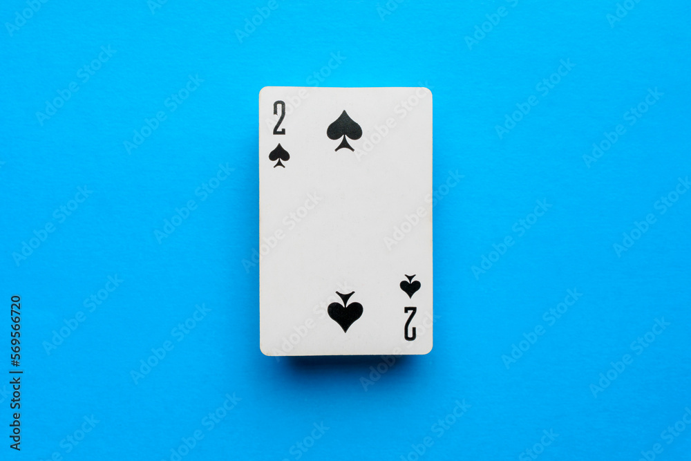 Playing card deuce of spades on a blue background Playing card deuce of spades on a blue background