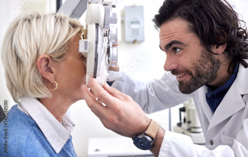 Doctor with woman in a vision test or eye exam for eyesight by doctor  optometrist or ophthalmologist with medical aid. Mature patient or client with a helpful optician to see or check glaucoma
