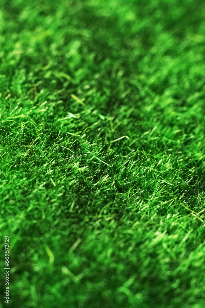 Naklejka premium Artificial green grass closeup, background or texture