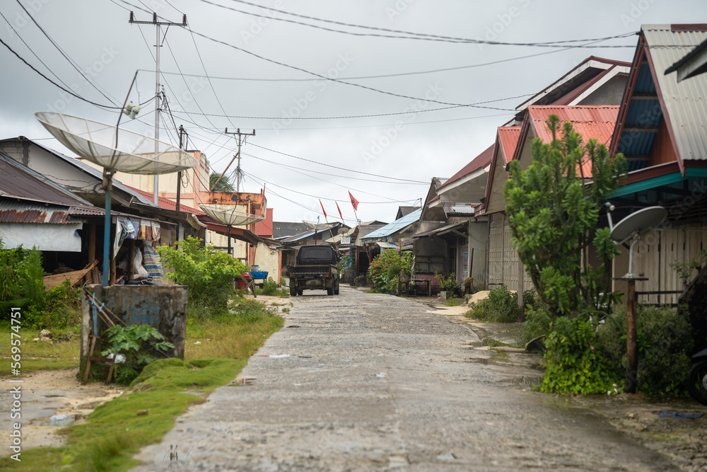 Exploring the Traditional Indonesian Town: A Scenic View of a Road with Houses Exploring the Traditional Indonesian Town: A Scenic View of a Road with Houses