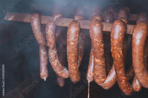 Home roasting of quality sausages made from home-made killer sausages, which are currently being smoked in a wooden shed at a precise temperature