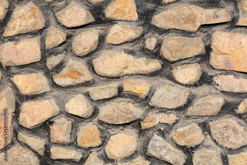 A wall of laid out stones as a background.