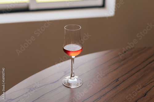 Wallpaper Mural A glass of yellow beverage traditional Portuguese sweet wine - muscatel on a wooden table Torontodigital.ca