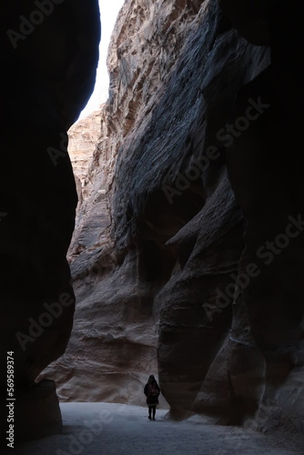 Silhouette of a girl walking in the Siq Canyon, Petra, Jordan
