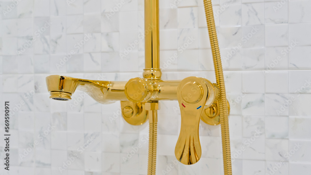 Gold-colored bathroom shower head that exudes a luxurious feel