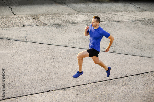 man athlete runner running on concrete road