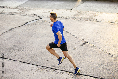 male runner to run morning jog along a concrete road