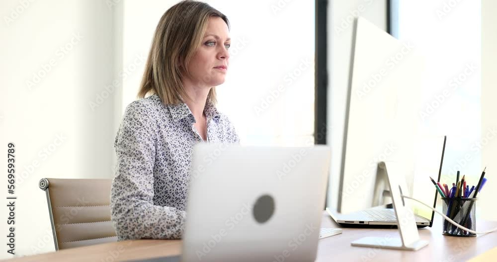 Focused business woman working at desk in creative office Focused business woman working at desk in creative office