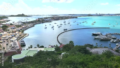 High point looking down on Bay of Marigot, St. Martin with the city waterfront and sailboats and luxury watercraft anchored in the harbor photo