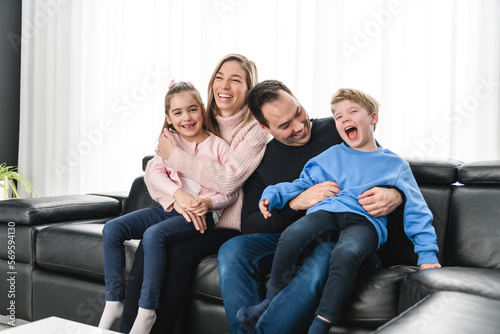 Family of four having fun on new modern house