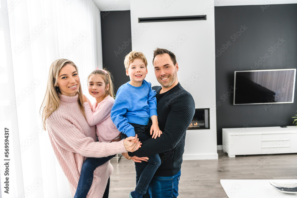 Family of four having fun on new modern house Family of four having fun on new modern house