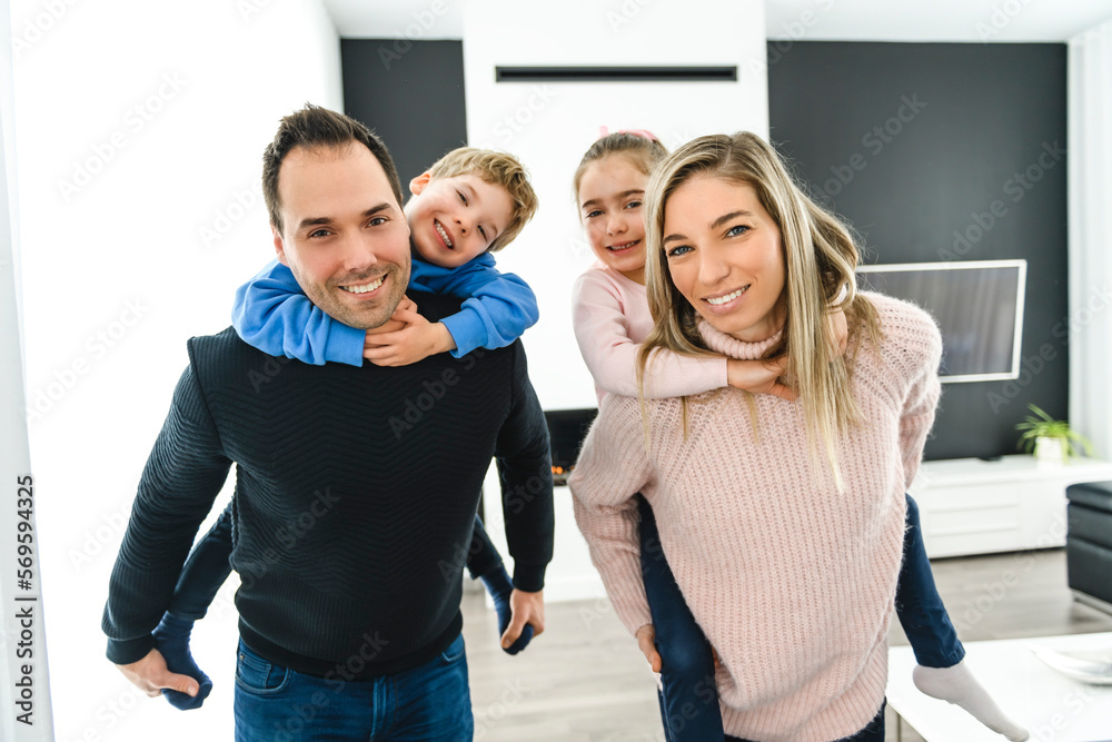 Obraz premium Family of four having fun on new modern house