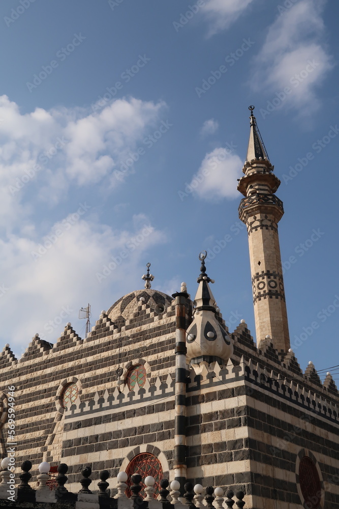 Architecture of the Abu Darwish Mosque, a black and white striped mosque in Amman, Jordan