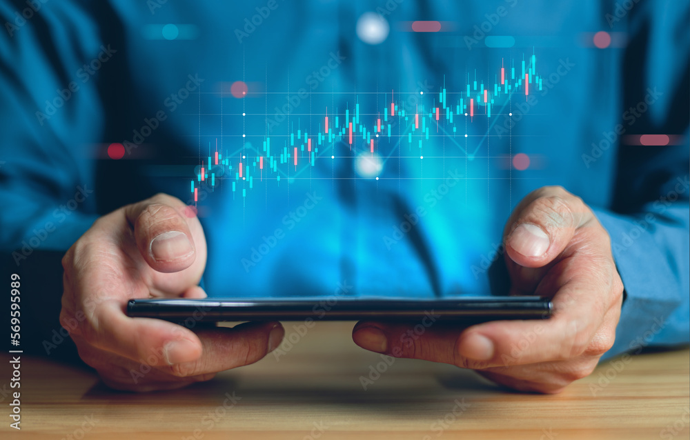 Stock market trading. Business man use smartphone monitoring and analysis graph stock.stock chart concept. Stock market trading. Business man use smartphone monitoring and analysis graph stock.stock chart concept.