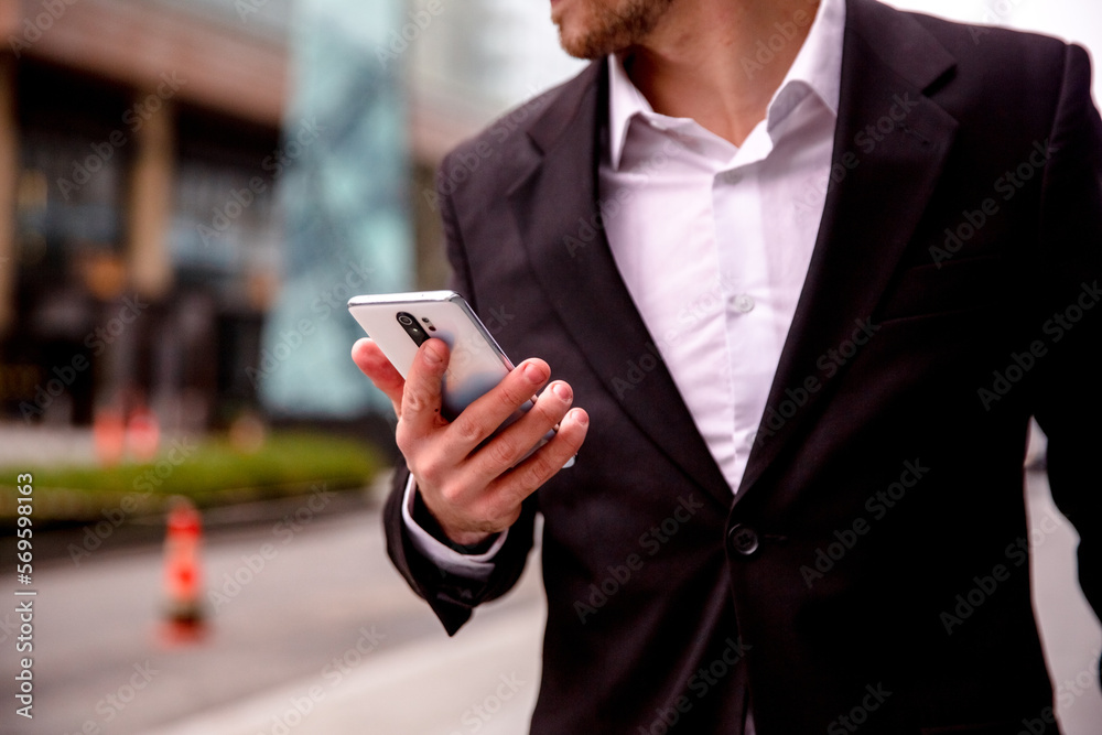 Portrait of a young businessman in a suit phone close up Portrait of a young businessman in a suit phone close up