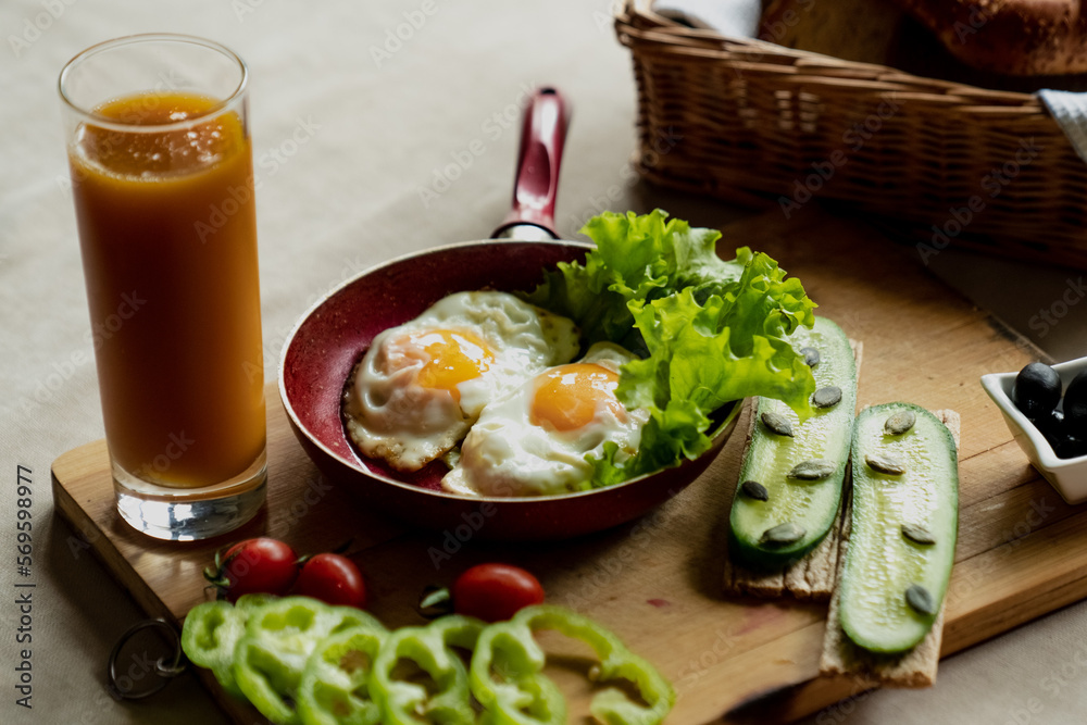 nice breakfast, scrambled eggs and a glass of fresh juice