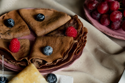 classic and chocolate pancakes with berries and fruits for breakfast, chocolate, tea,
