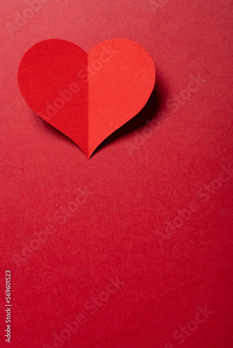 a heart on a red background with copy space at vertical composition