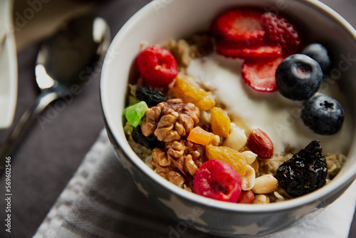 oatmeal with berries and nuts, yogurt, close-up