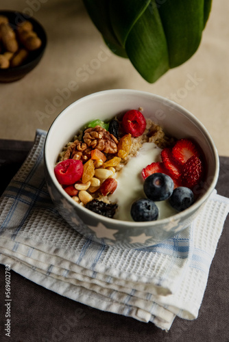 Beautiful breakfast oatmeal with yogurt and berries, nuts