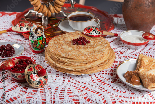 Russian pancake blini with berries and sour cream on the table. Shrovetide Maslenitsa festival concept. Top view. Flat lay